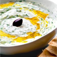 a white bowl filled with dip and crackers