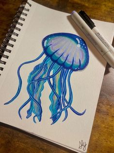 a drawing of a jellyfish on a notebook