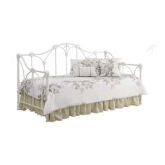 a white metal daybed with ruffled bedspread and pillows on it's sides