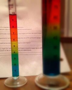 two test tubes filled with colored liquids on top of a table