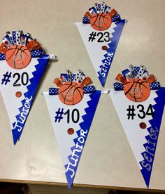 three basketball themed pennants with numbers on them