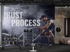 a man is working out in the gym with dumbbells and exercise ropes,