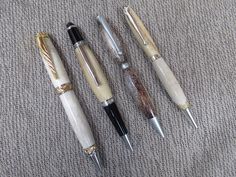 three different types of pens sitting on top of a cloth covered floor next to each other