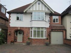 a large white brick house with two garages