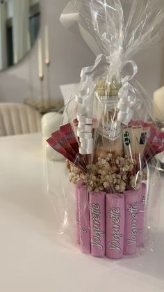 a basket filled with lots of candy and candies on top of a white table