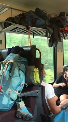 people sitting on a bus with backpacks and luggage