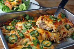 a casserole dish with meat, cheese and green peppers