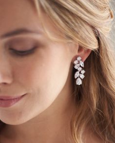 a close up of a person wearing some kind of earrings