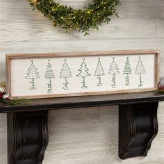 a wooden sign sitting on top of a shelf in front of a wreath and christmas decorations