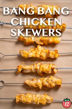 chicken skewers are lined up on a baking sheet with the words bang bang chicken skewers