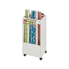 a white cart filled with lots of books and wrapping paper on top of each other