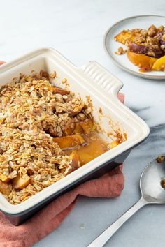 a white dish filled with oatmeal sitting on top of a table