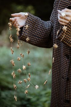 a person holding something with gold stars on it's back and hands in the air