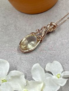 This gorgeous wire wrapped pendant features a stunning oregon sunstone oval-cut facet wire wrapped in 14k rose filled wire.  This pendant is a gorgeous collector's piece, perfect for a wedding gift or bridal necklace or a meaningful anniversary gift. About the Pendant: - 100% handmade - Genuine, natural oregon sunstone, 18mm x 14mm - Non-tarnish 14k rose gold filled wire - Safe for daily wear - Suitable for those with metal allergies or sensitivities - One-of-a-kind piece A 14k rose gold filled chain will be included with the pendant.  The piece will ship in a pendant box and will include care instructions in the package.  The piece will be professionally polished prior to shipping so that it arrives sparkling and ready to wear. Return Policies: Our work is guaranteed!   - We offer repair Wire Wrapped Crystal Pendant, Oregon Sunstone, Wire Wrapping Crystals, Jewelry Wire, Wrapped Jewelry, Jewelry Unique, Wrapped Pendant, Bridal Necklace, Wire Wrapped Pendant