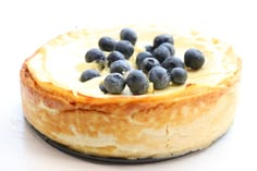 a cheesecake topped with blueberries on a plate