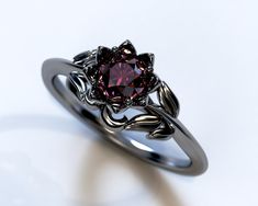 a close up of a ring with a purple stone in the center and vines on it