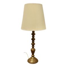 a table lamp with a white shade on it and a cord attached to the base