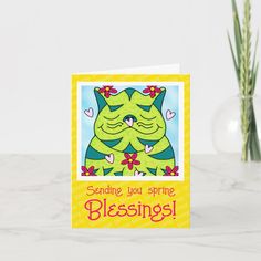 a greeting card with an image of a green cat on it and the words sending you spring is blessing