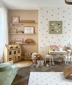 a child's room with pink and white wallpaper, wooden furniture and toys