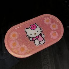 a hello kitty lunch box with flowers on it