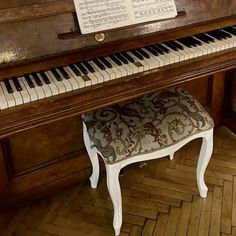 an old piano with a bench in front of it