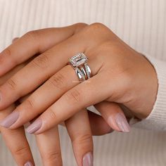 a woman's hand with two rings on her fingers