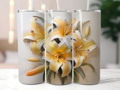 three white vases with yellow flowers painted on them