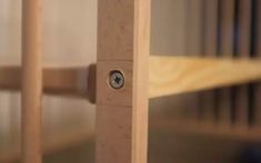 a close up view of a wooden frame with an eye hole in the middle and wood slats behind it