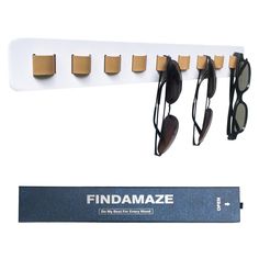 a rack with sunglasses hanging from it's sides and an eyeglass holder attached to the wall