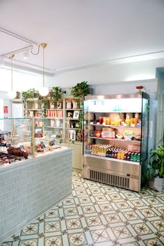 the interior of a deli filled with lots of food and drink bottles on display