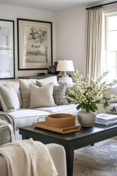 a living room filled with lots of furniture and flowers on top of a coffee table