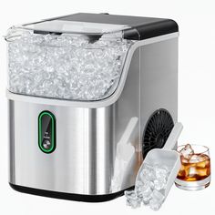 an ice maker with two glasses next to it on a white background and one is filled with ice