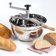 bread, loaves and butter sit in front of a mixing bowl on a white background