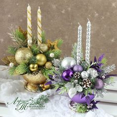 two vases filled with christmas decorations sitting on top of a window sill