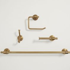 two brass bathroom accessories on a white background