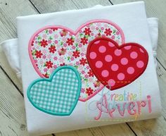 two hearts appliqued on a white t - shirt