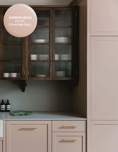 a kitchen with brown cabinets and white counter tops, along with an oval sign that says summer recipe