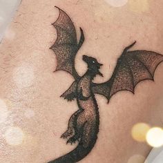 a black and white photo of a dragon tattoo