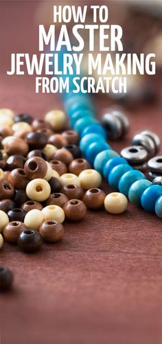 a bunch of beads sitting on top of a table with the words how to master jewelry making from scratch