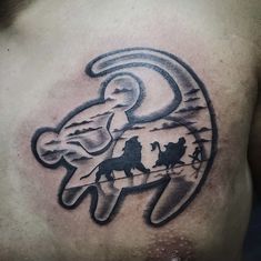 a man's chest with an image of two horses and a moon on it