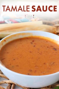 a bowl of tomato soup on a wicker place mat with the words tamale sauce above it