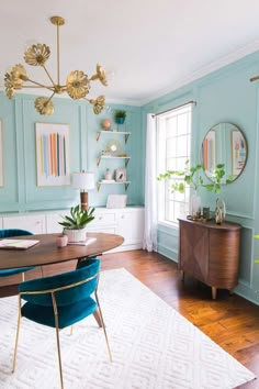 a dining room with blue walls and gold accents