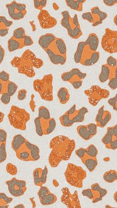 an orange and gray animal print pattern on white paper with glittery spots in the middle