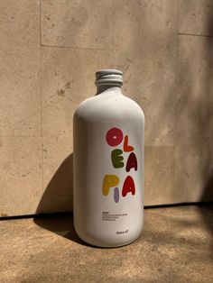 a white bottle sitting on top of a counter