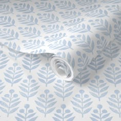 a blue and white wallpaper with leaves on it