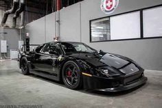 a black sports car parked in a garage