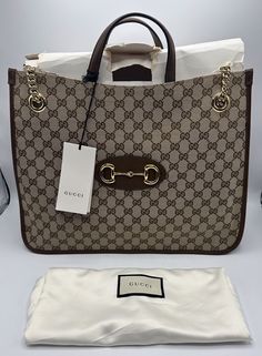 UP FOR SALE TODAY Gucci Horsebit Chain Tote 1955 GG Canvas Medium Brown Monogrammed *New, opened* Item shows slight wear on exterior from handling (light scuffing on bottom [see pics 15 & 18]) and the cardboard inside is opened (see images for more details) Gold hardware shows no wear Measures 12.5" (28" including strap) x 13.5" x 5" Comes exactly as pictured. Please see pictures for more detail Free Shipping inside the Contiguous U.S.A This item is for sale through eBay ONLY! Please don't ask us to sell off eBay! Payment & Checkout Payments:  We accept PayPal only for online purchases but will accept cash, debit or credit card if paying at our physical store. Payments must be received within 3 days.  Unpaid cases will automatically be opened by eBay 3 days after purchase. Taxes: Buyer mus Luxury Purses Gucci Bags, Gucci Bags Handbags, Gucci Beige Bags With Gold-tone Hardware, Elegant Gucci Bag With Gold-tone Logo Plaque, Gucci Bag With Gold-tone Hardware And Top Handle, Gucci Coated Canvas Shoulder Bag With Gold-tone Hardware, Gucci Canvas Bags With Gold-tone Hardware, Gucci Horsebit, Luxury Purses