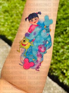 a person with a cartoon tattoo on their arm