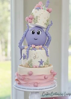 a purple and white cake with an octopus on top