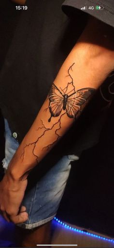 a person with a butterfly tattoo on their arm